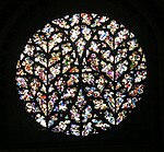England Lincoln Cathedral, the Bishop's Eye. Fragments of ancient glass in a Flowing Gothic window