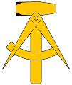 The National emblem of East Germany, a compass and hammer.