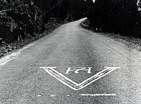 Resistance graffiti on a Norwegian road, depicting the V-sign, "V" in Morse Code, and the royal cipher of King Haakon VII