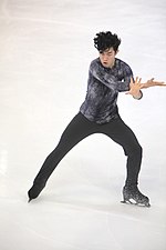 A photograph of Nathan Chen performing his free program at a competition in France.