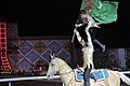 Turkmen man and his son hoist the flag of Turkmenistan while on horseback at the opening ceremony for the 2008 World Nomad Games.