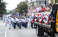 A group of delayed entry program recruits follows behind a truck full of Sailors during the Orlando, Fla., Veterans Day Parade.