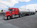 A B-double tanker parked at a truck stop