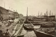 Vessels docked along a seafronting street in the city circa 1910.