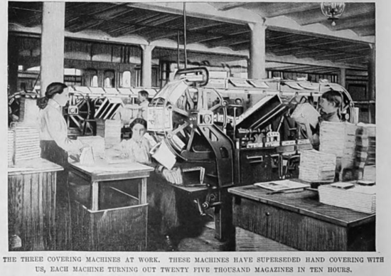 Three people working at a large machine