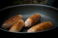 Frying pork sausages in a pan