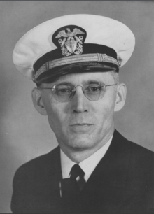 the article subject dressed in a jacket, necktie, and sailor cap