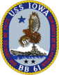Seal of the Battleship USS Iowa (BB-61), featuring a blue and gold trim around a small image of the battleship and an eagle in the air. The words "USS Iowa" and "BB 61" can be seen at the top and bottom of the circle, while the left and right of the circle contain the words "our liberties we prize" and "our right we will defend", respectively.