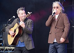 China Crisis performing at Let's Rock Liverpool in 2021, left to right: Eddie Lundon (guitar) and Gary Daly (vocals).