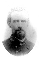 Black and white oval-shaped photo of a man with a trimmed beard in a military uniform.