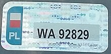 A holographic, rectangular sticker resembling a standard license plate. It reads WA92829
