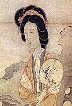 A woman holding a flat oval fan with a Chinese painting from the painting "Appreciating Plums" by Chen Hongshou (1598–1652).