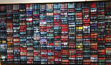 A wall covered with a bewildering array of different samples of tartan cloth