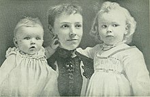 Helen Taft as a young woman holds a small child in each arm