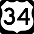 A highway sign in the shape of the United States shield bearing the number "34"