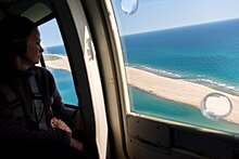 A visitor views an area of Sable Island National Park Reserve from a helicopter