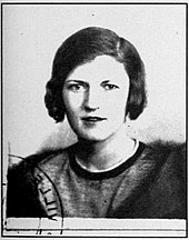 A black and white, heavily exposed photograph of an older Zelda Fitzgerald used for her French identity card. She is staring at the camera and appears slightly haggard. She has dark brown hair and has a rather distant gaze.