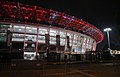 Post-renovation stadium illuminated with changing colors LED lights (red shown) on the nights during the 2018 Asian Games