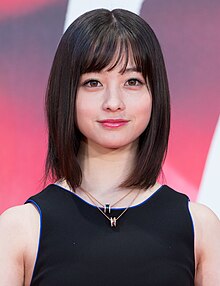 Kanna Hashimoto in sleeveless dress facing camera with arms lowered and hands folded in front of body