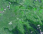 Satellite image of a green valley dominated by farming and agriculture
