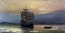 A late afteroon color painting of the sailing ship Mayflower near Plymouth harbor. The sun is behind the clouds to the west with the coast in semi-darkness. Sails are set and catching the light of the setting sun.