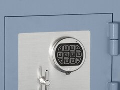 Digital keypad of an electronic safe, on a circular escutcheon mimicking a mechanical combination dial