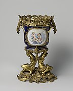 Rococo Revival jardinière with putti and flower sprays, set in a metal frame