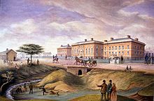 A painting of the Parliament Buildings of Upper Canada, depicted in brown in the background facing leftward while people mingle along a road and creek in the foreground.
