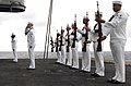 Sailors of US Navy present arms during burial on sea on aircraft carrier USS Harry S. Truman.