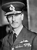 Monochrome photograph of Hugh Dowding in Air Chief Marshal's braided cap and plain uniform jacket with wings and cloth medal strip