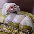 Khao tom mat, sticky rice and banana steamed inside a banana leaf