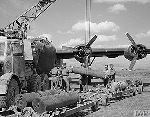 No. 178 Squadron ground crew preparing to load a Liberator bomber with mines