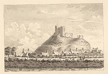An etching of Criccieth Castle, showing the ruins on their hill with Criccieth town and fields in the foreground.