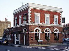 Photograph of a two-storey red brick building with signage indicating it is a pub called the Duchy Arms