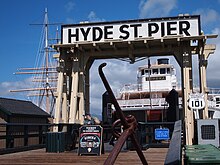 An overhead structure labeled "Hyde St. Pier" frames a historic ferryboat alongside a US 101 shield and older sailing ship.