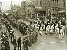 a black and white photograph of a military procession