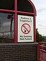 Bilingual, English–Latin station platform and no smoking sign