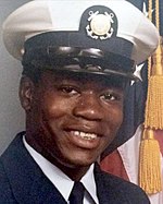 Portrait photo of Walter Scott in U.S. Coast Guard uniform with an American flag partially visible in the background.