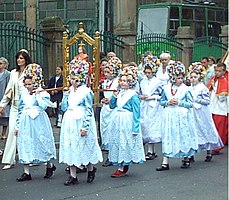 Corpus Christi procession in Poznań, Poland, 2004: little girls carrying an Infant Jesus of Prague statue, followed by altar servers clothed in surplice and cassock