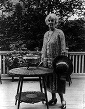 Hoover stands next to a wicker table