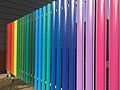 Colorful metal picket fence in Russia