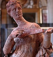 Tanagra figurine playing a pandura, 200 BC