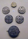 Openwork silver disk brooches