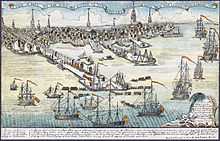 A wide view of a port town with several wharves. In the foreground, there are eight large sailing ships and an assortment of smaller vessels. Soldiers are disembarking from small boats onto a long wharf. The skyline of the town, with nine tall spires and many smaller buildings, is in the distance. A key at the bottom of the drawing indicates some prominent landmarks and the names of the warships.