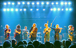 Broken Social Scene performing in England in 2006. Left to right: Brendan Canning, Ohad Benchetrit, Torquil Campbell, Kevin Drew, Andrew Whiteman, Julie Penner, Lisa Lobsinger