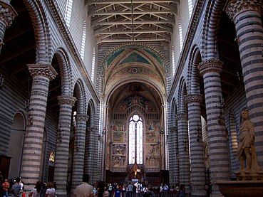 The nave of Orvieto Cathedral, Italy, has two stages: arcade and simple clerestory windows separated by a cornice.