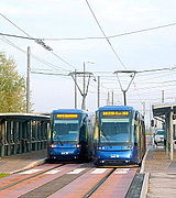 Tram leaving (at left) and arriving (to the right) at the southern terminus.