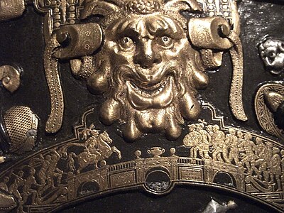 Detail from the Ghisi Shield; a grotesque head in the larger scale above Horatius at the bridge in the smaller