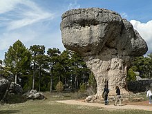 A rock wider at the top than at the base.