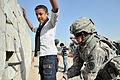 Image 10U.S. Army soldier searches an Iraqi boy, March 2011. (from History of Iraq)